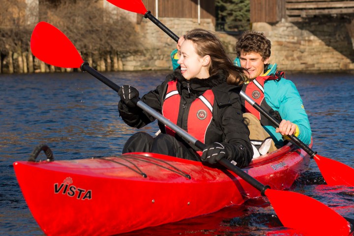 a person riding on the back of a boat in the water