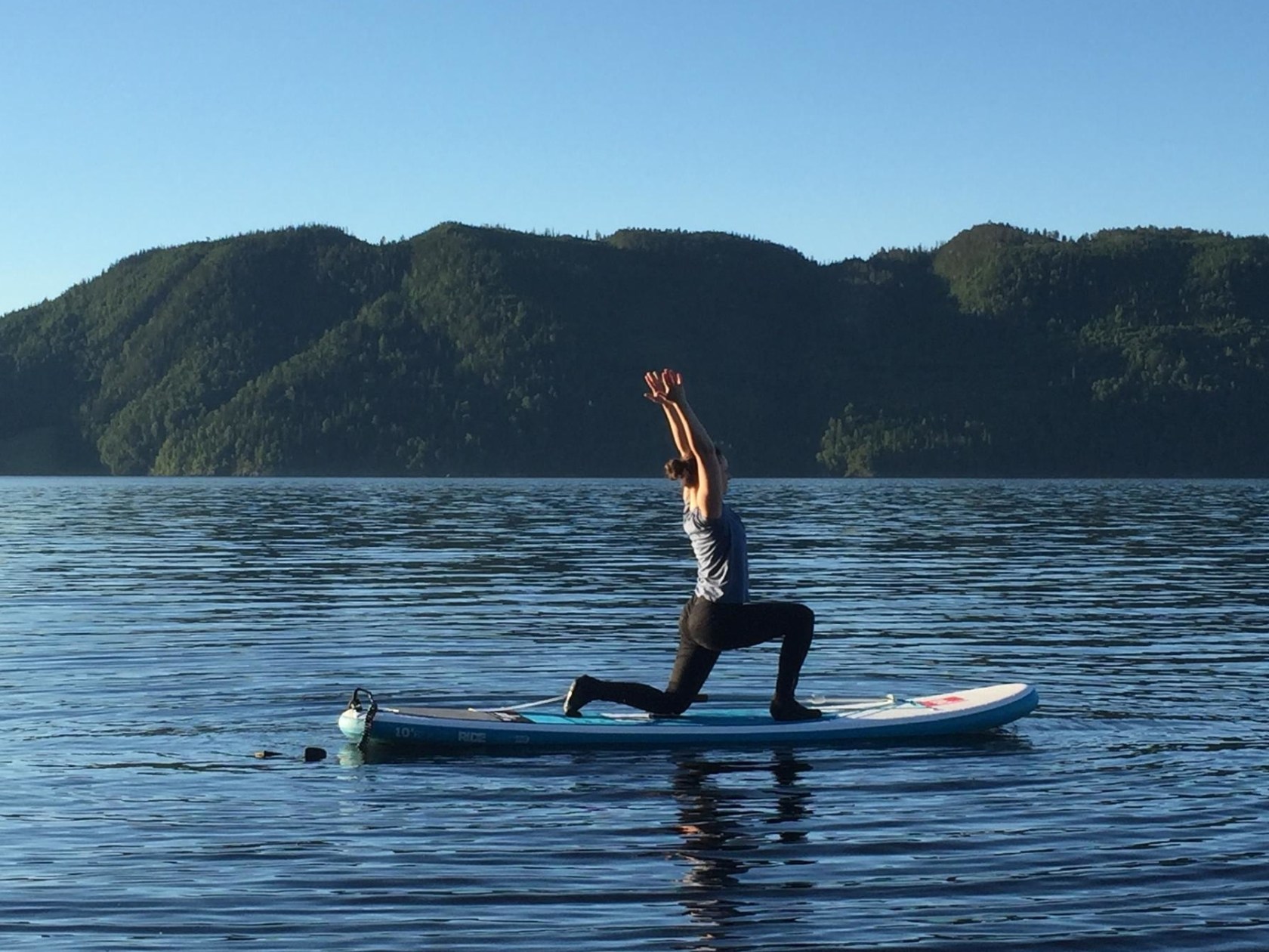 a man riding a board on a body of water