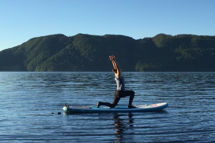 a man riding a board on a body of water