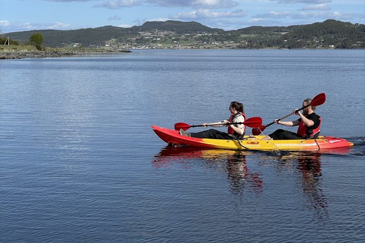 a group of people in a small boat in a body of water