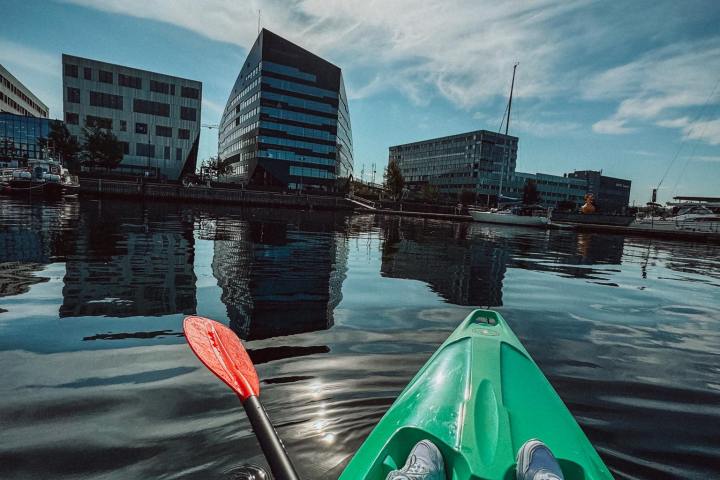 a green boat on a body of water